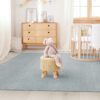 Scandinavian children’s room: a basket for toys, a plush rabbit