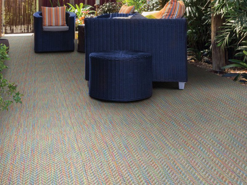 Rainbow carpet blue couch