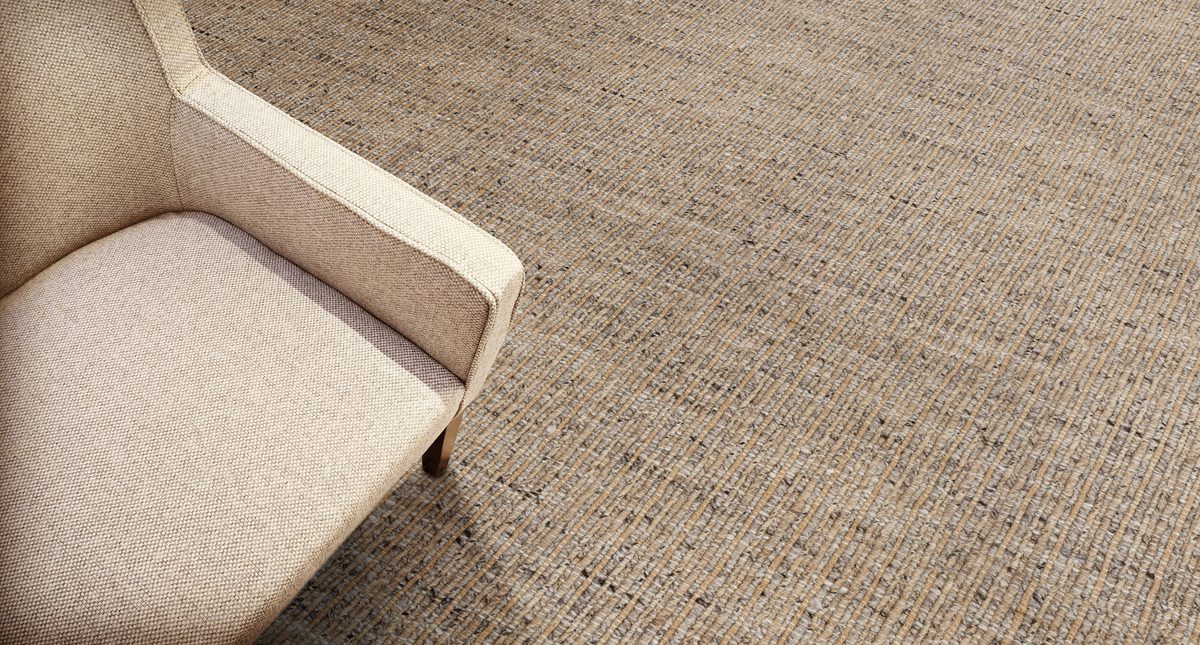 Beige textile armchair on a carpet