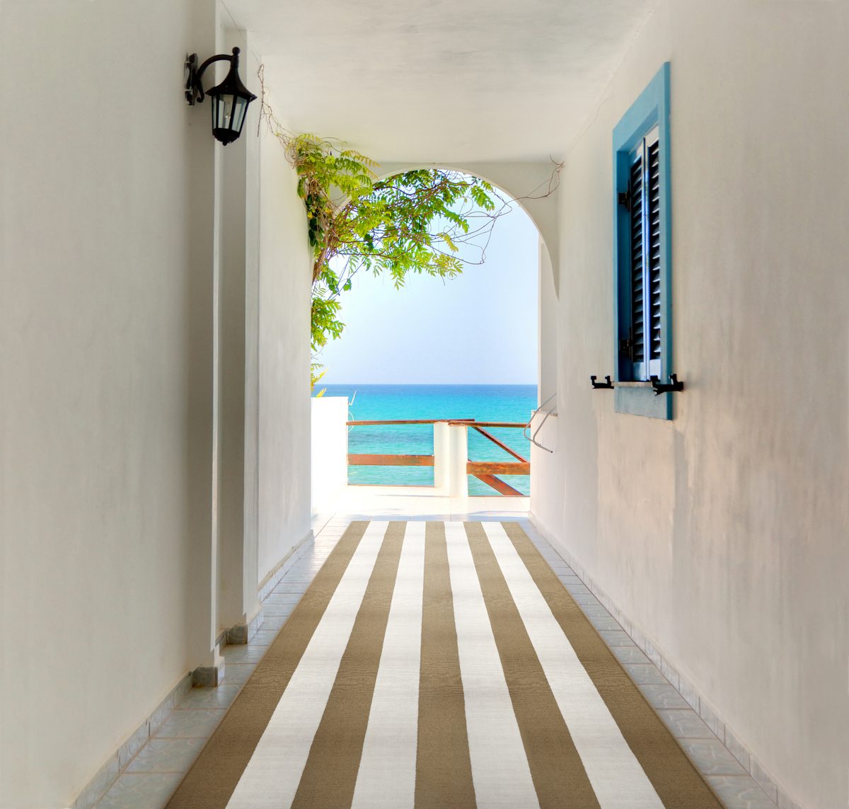 Walkthrough between the houses to the beach in a Greek town on t