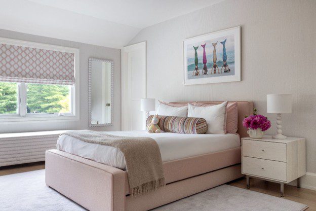 brightly lit bedroom by Ali Milch interiors with a king sized bed and neutral brown, tan, and white colors.