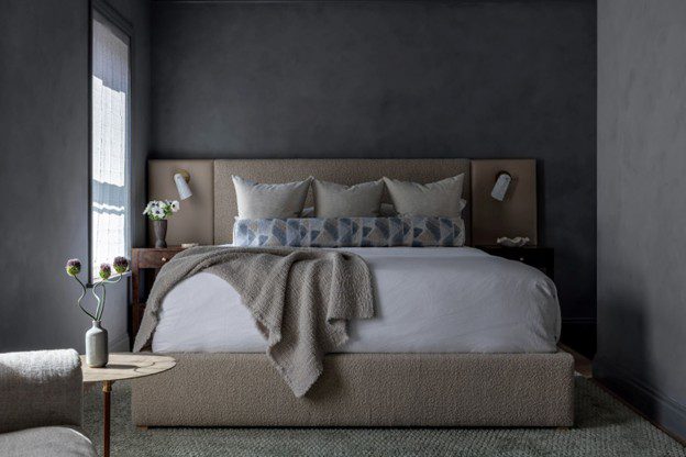 dark cozy bedroom with a king size bed with brown coloring